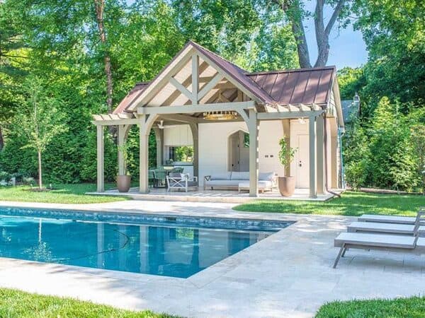 Outdoor living space building next to backyard pool