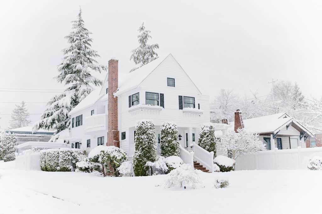 Residential home in winter with brick chimney.