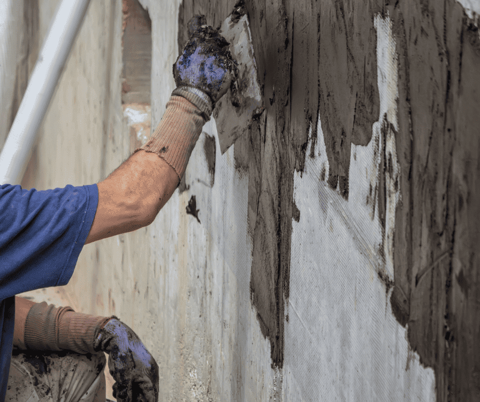 Man parging a masonry wall