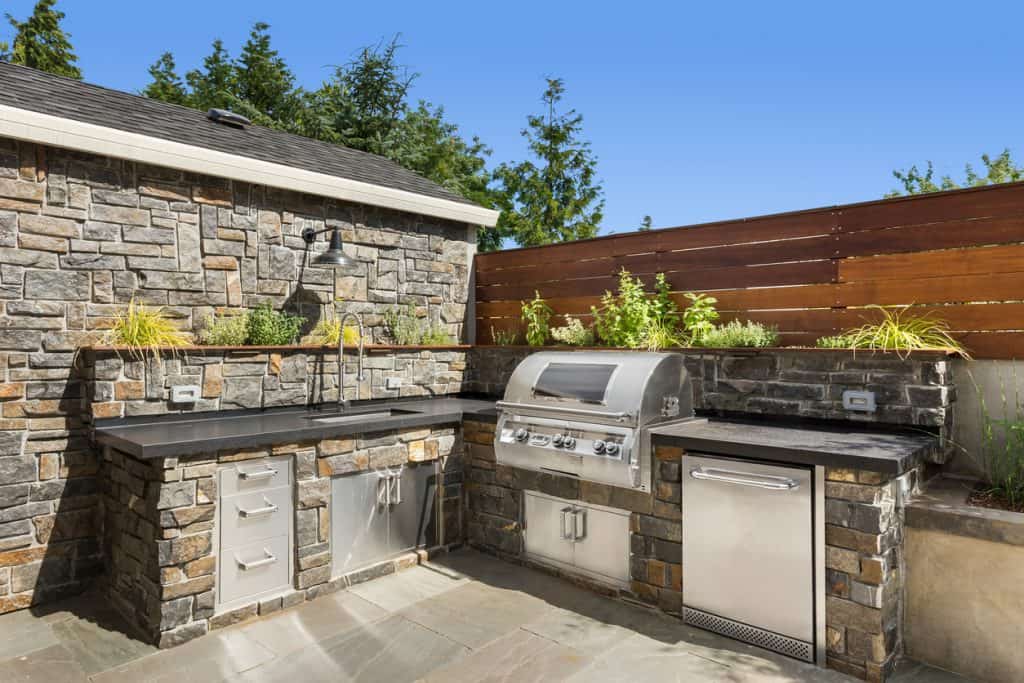Backyard hardscape patio with outdoor kitchen.