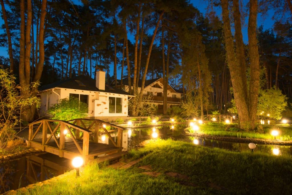 Outdoor lighting of a home beside a lake