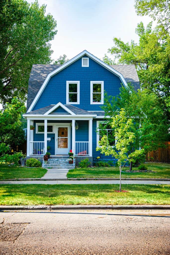 A charming home with a small porch.