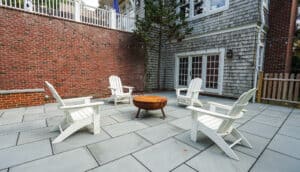Patio with chairs surrounding a fire pit